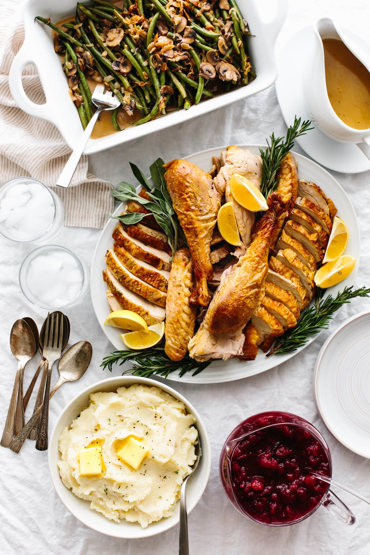 Plates of Thanksgiving recipes on a table.