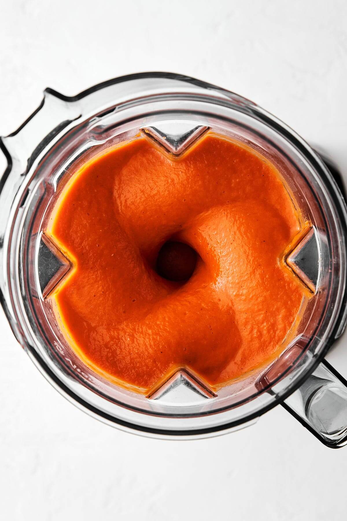 Blending tomato soup in a blender.