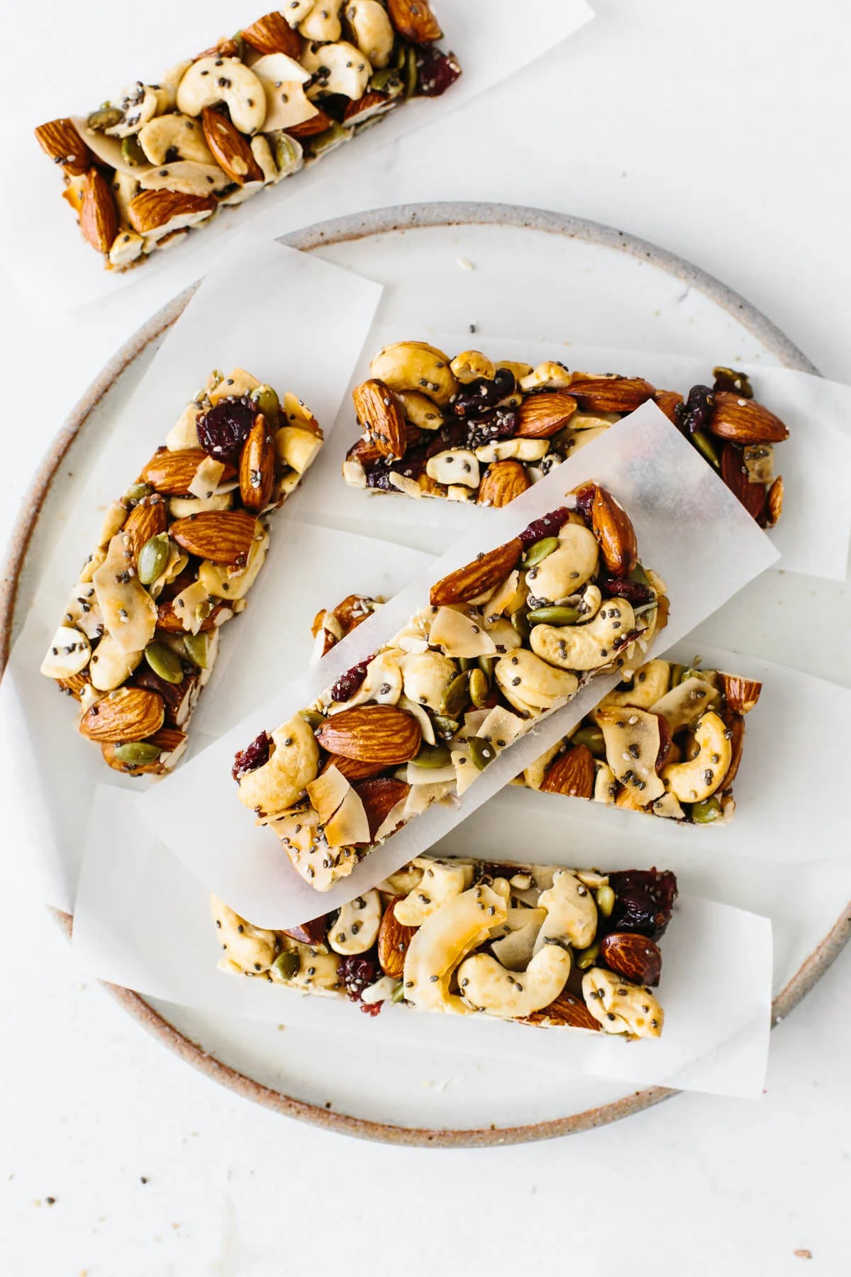 Several trail mix granola bars on a plate.