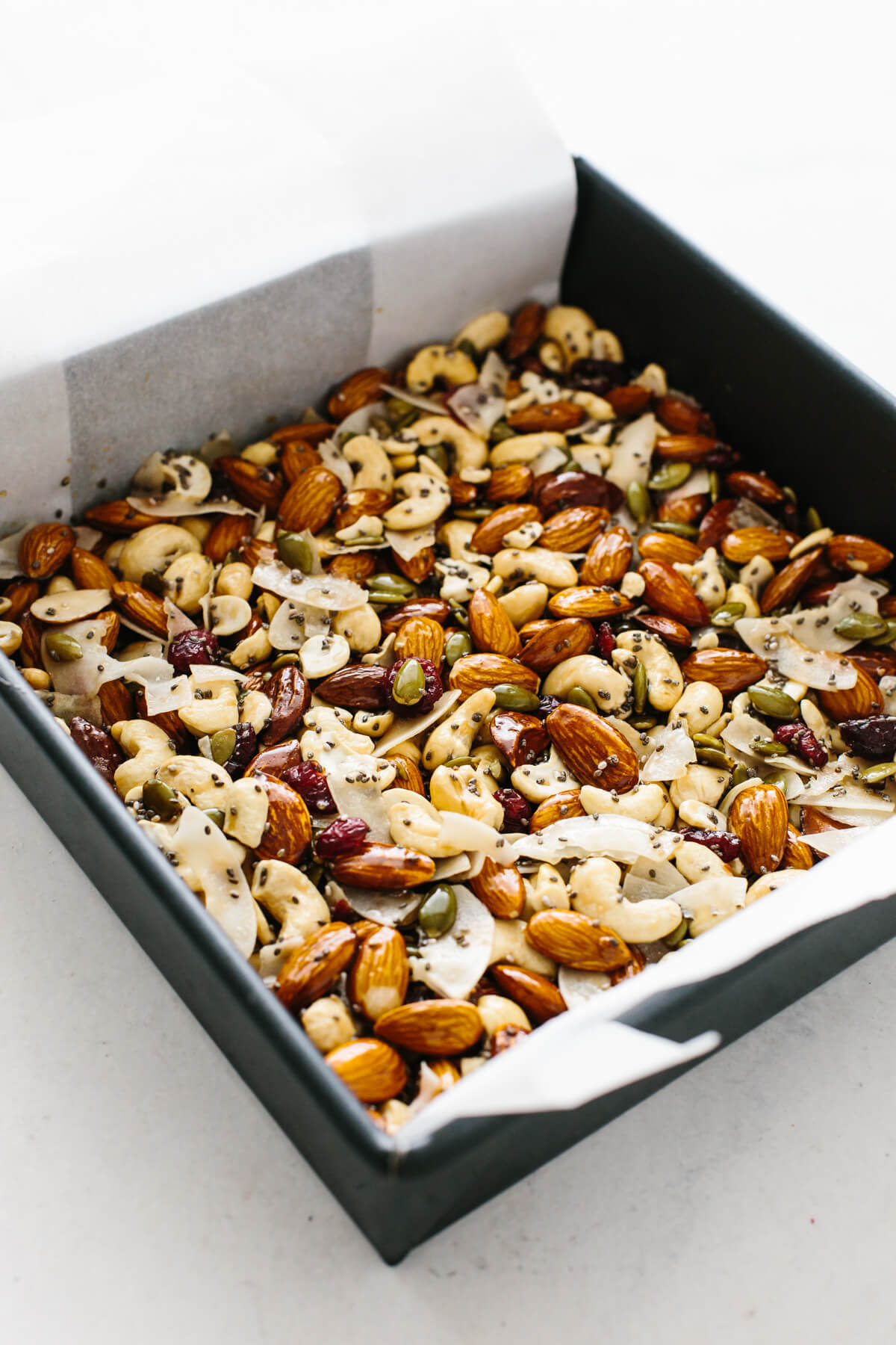 Homemade granola bar ingredients in a baking pan.