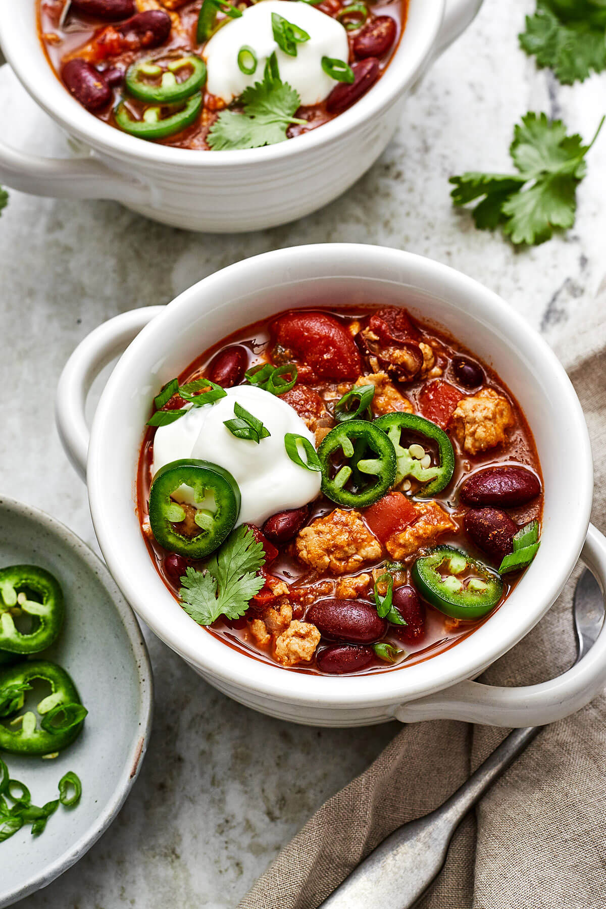 Bowls of turkey chili with jalapenos