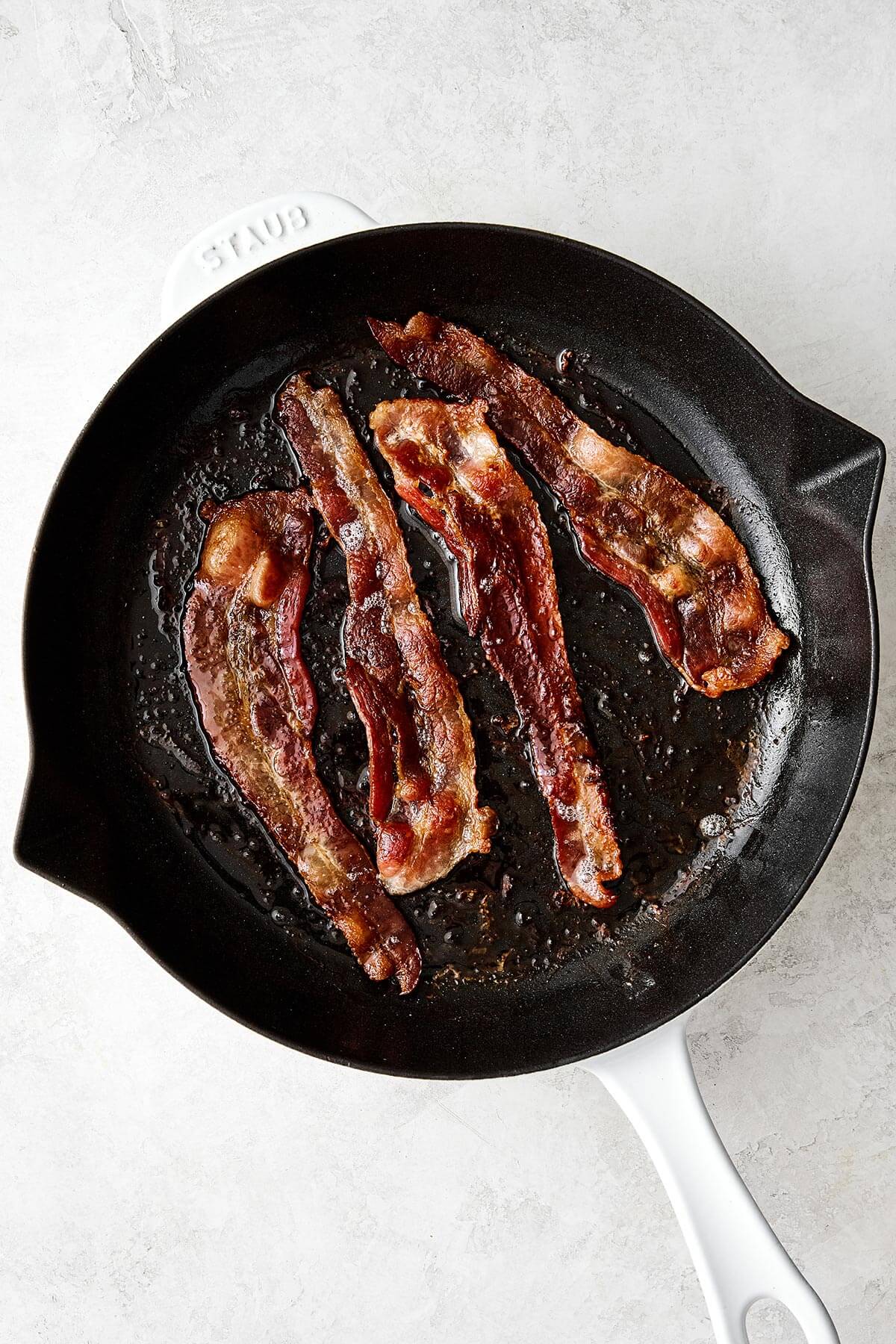 Cooking bacon in a pan.