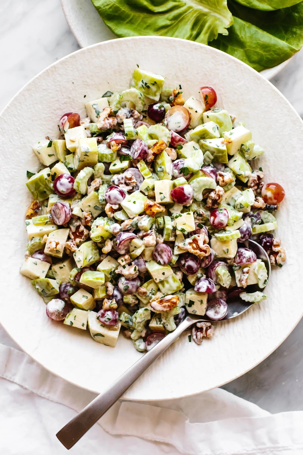 Waldorf salad in a large white bowl.