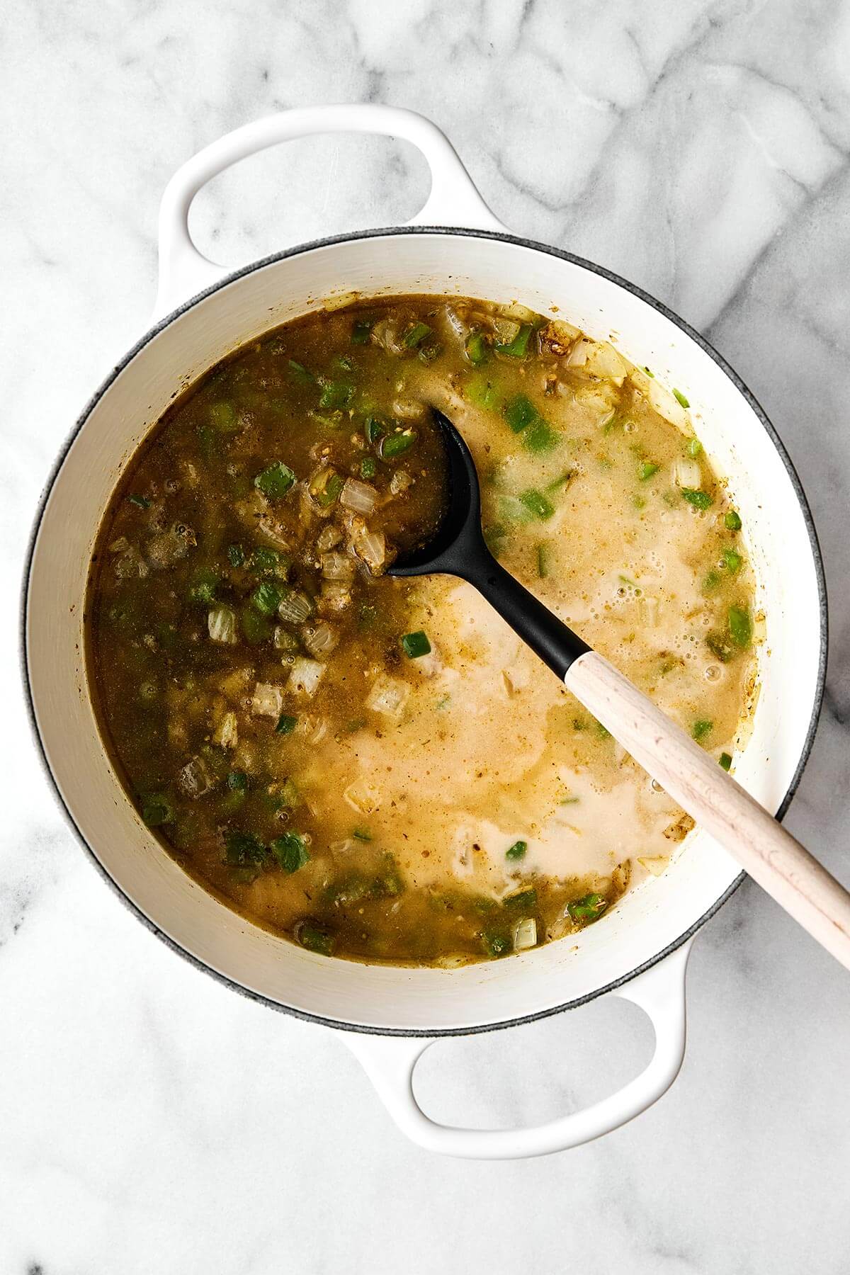 A pot cooking white chicken chili.