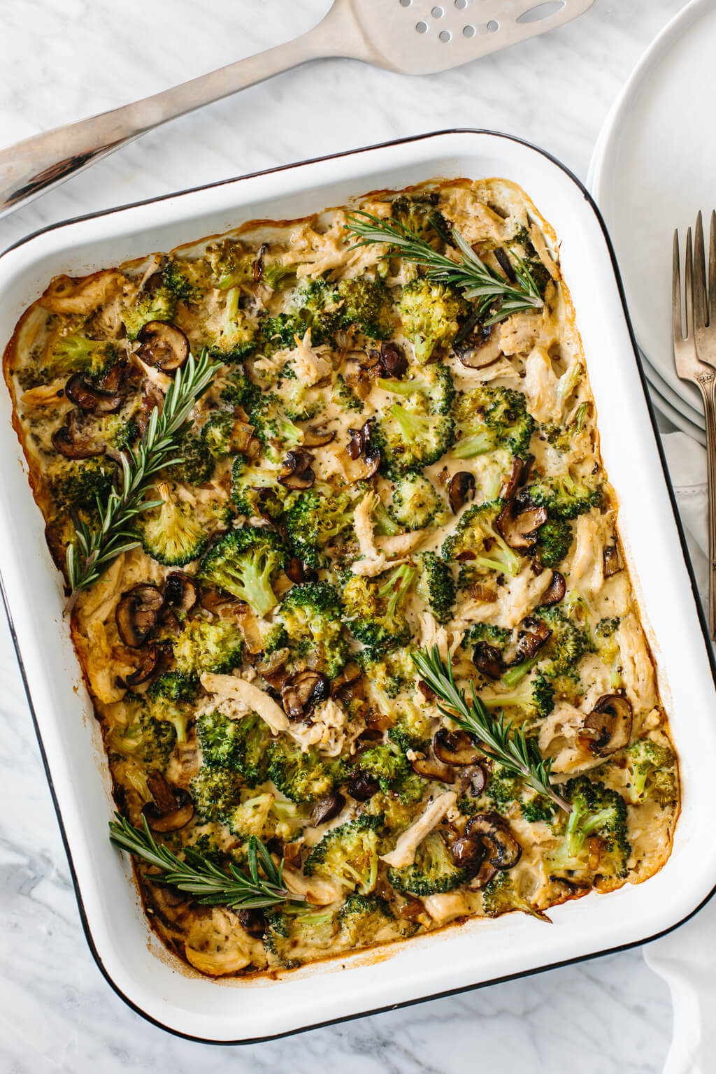 Whole30 casserole recipe with shredded chicken, sautéed mushrooms and broccoli, then topped with my Vegan Alfredo Sauce for an easy and healthy weeknight dinner. It's also a dairy-free and paleo casserole recipe.